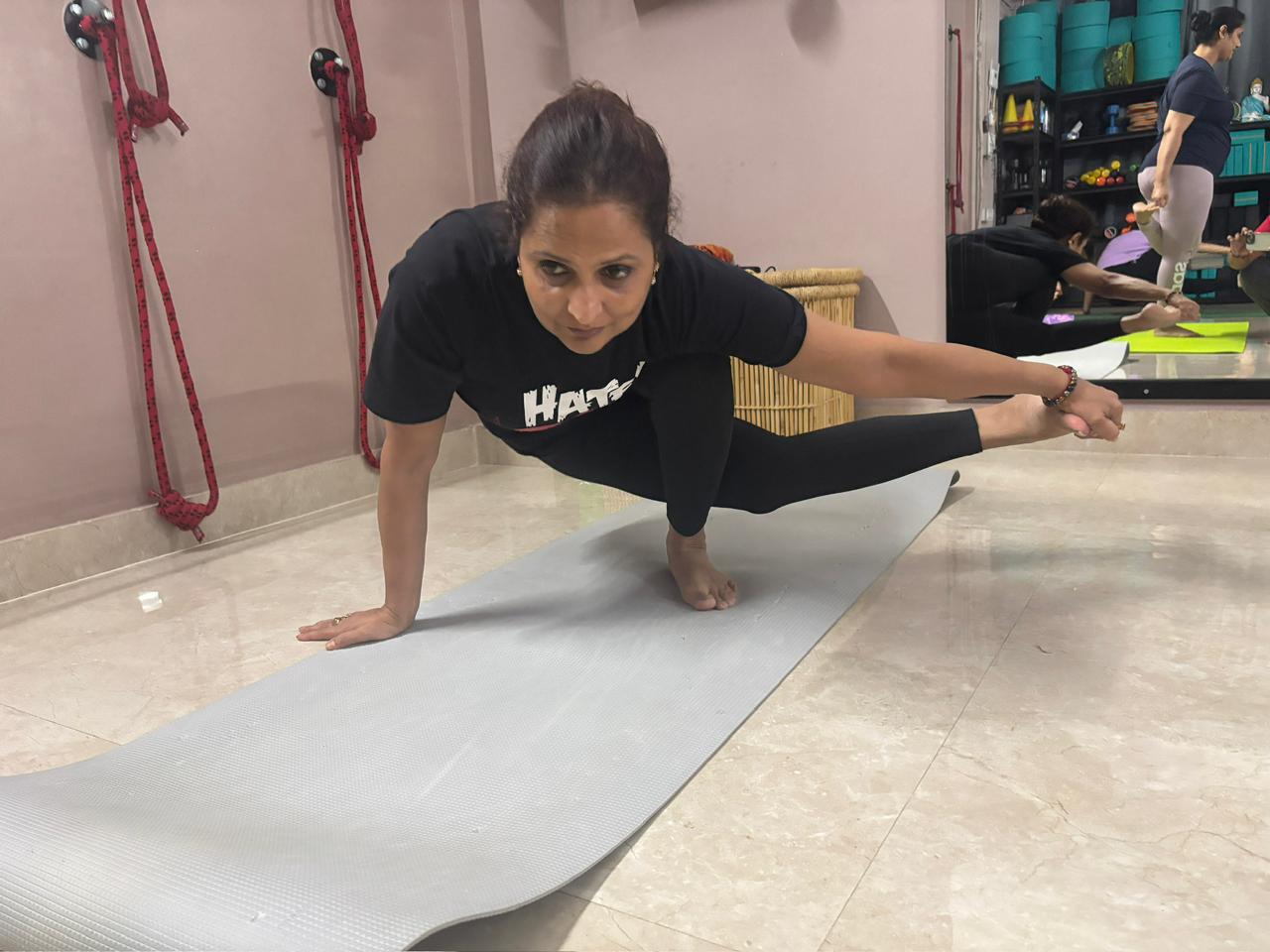 Deepika practicing strength and flexibility through an advanced yoga posture at Attmashuddhi